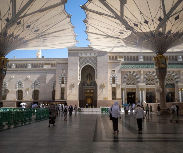 Medina, Saudi Arabia - June 30, 2024: Hajj and Umrah pilgrims under the giant automatic umbrellas in Prophet Mosque in Madinah, also known as Masjid Nabawi, Saudi Arabia.